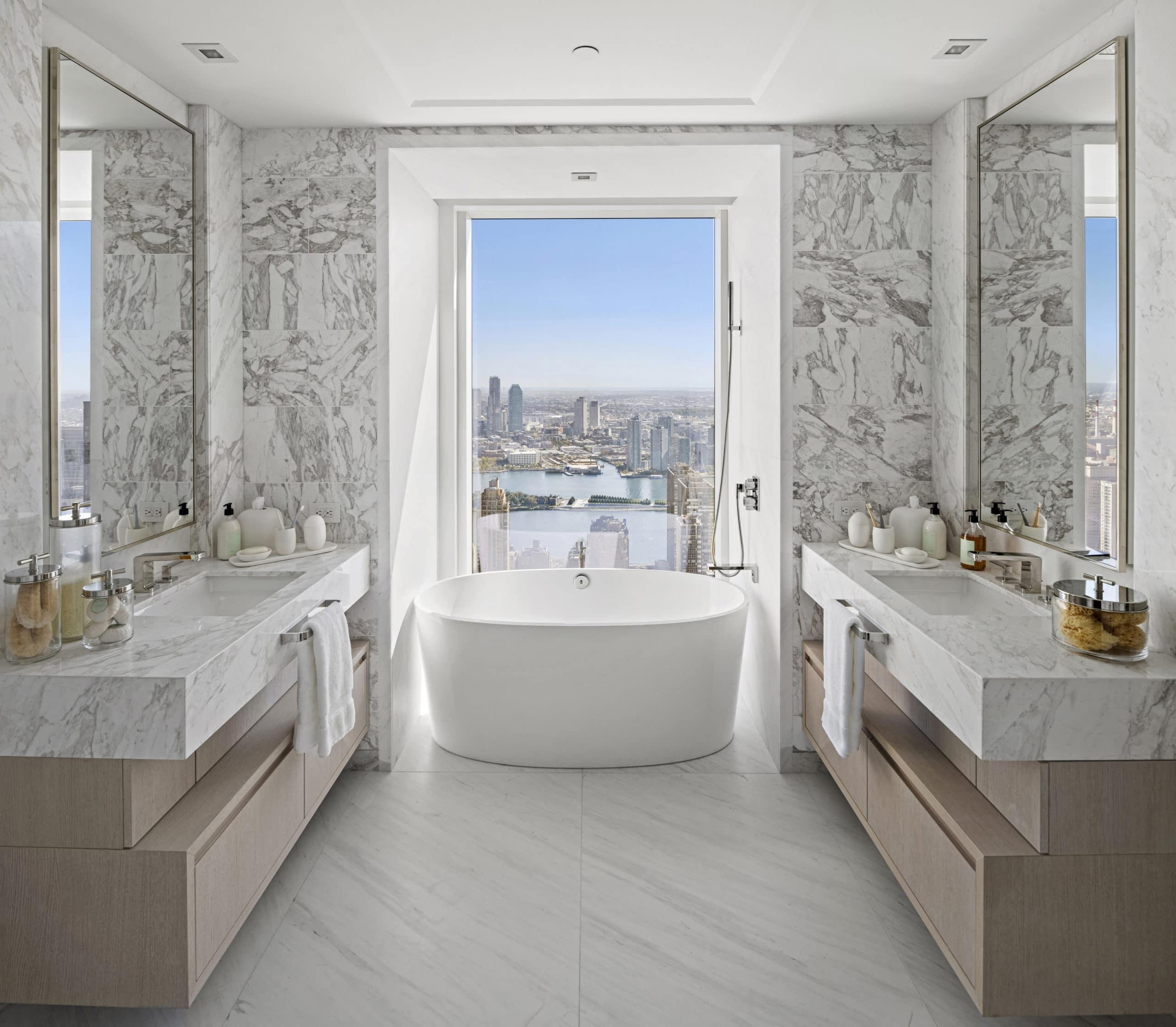 Bathroom at The Centrale in New York. Condo bathroom with double vanities and large soaking tub overlooking Manhattan.