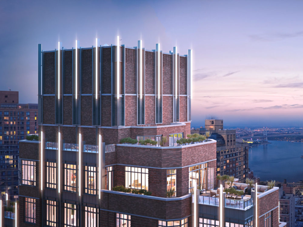 Birdseye view of the Kent penthouse in New York City. Brick exterior with rooftop patio with unobstructed city views at dusk.