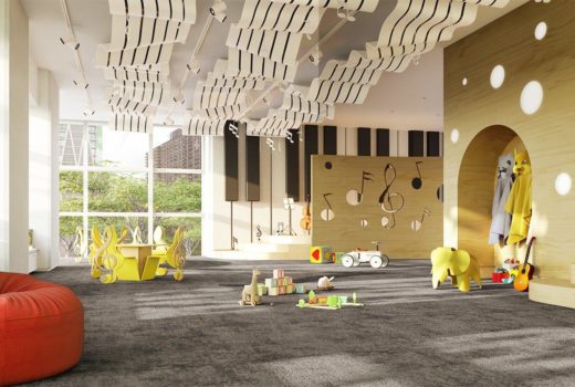 Interior view of playroom inside 200 Amsterdam condominium in NYC. Includes toys, red furniture, and sculpture ceiling.