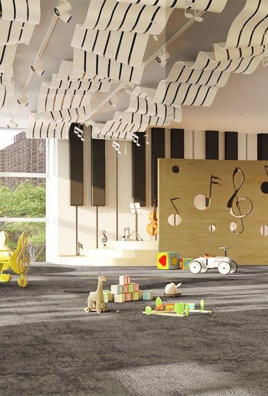 Interior view of playroom inside 200 Amsterdam condominium in NYC. Includes toys, red furniture, and sculpture ceiling.