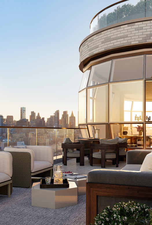 Exterior view of Lantern House residence terrace in NYC. Has lounging furniture with a fireplace in the middle.