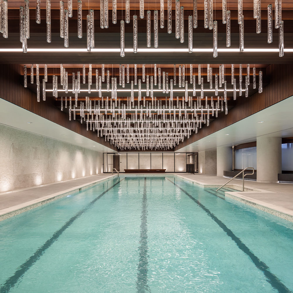 Indoor pool at One Manhattan Square luxury condominiums in NYC. Four lane lap pool with sauna and sitting area.