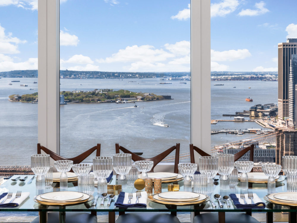View of the East River in New York City from condo dining room with floor-to-ceiling windows at One Manhattan Square.