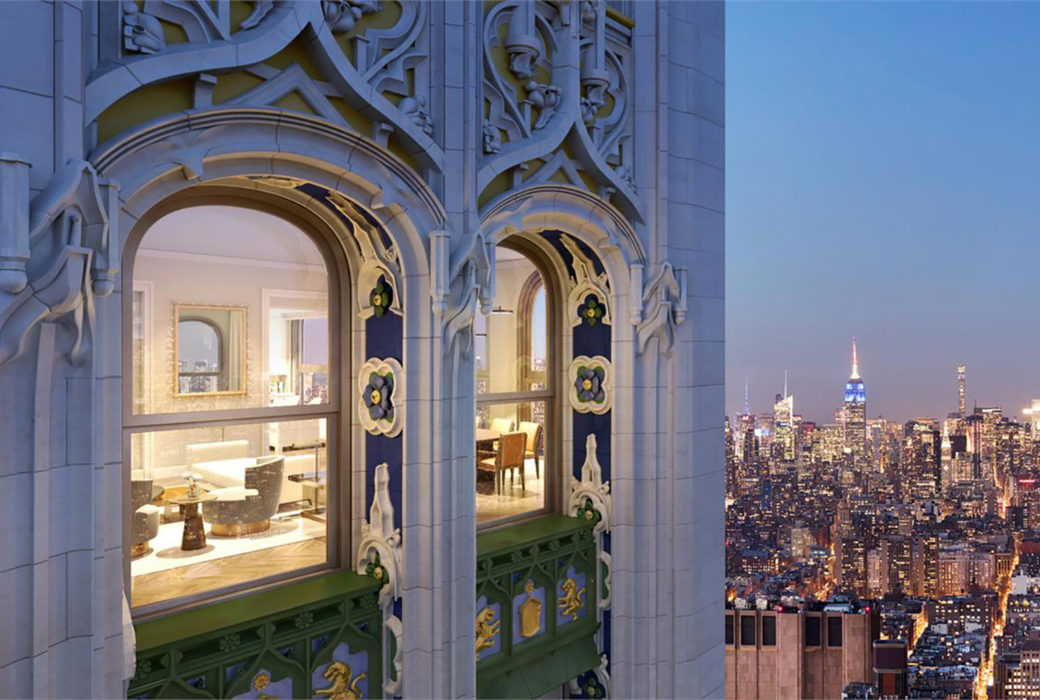 Exterior of the Woolworth Tower residences in New York. Gothic design and arched windows overlooking city skyline at night.