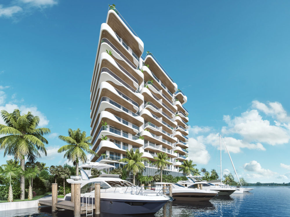 View of Monaco Yacht Club luxury residences in Miami taken from the docks with boats and palm trees in the forefront.