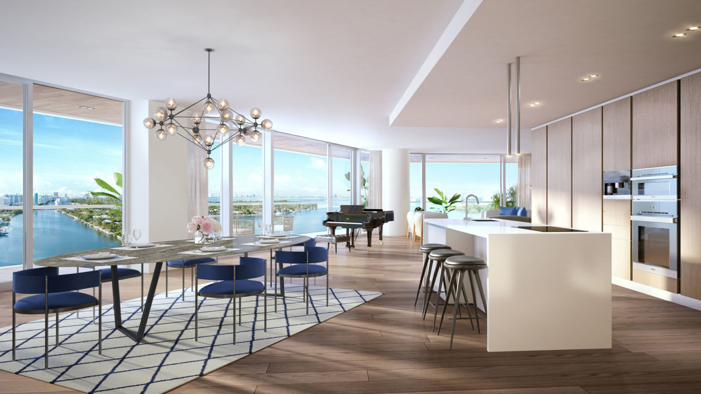 Interior view of Monaco Yacht Club residence kitchen and dining room. Has window view of the ocean and wooden floors.