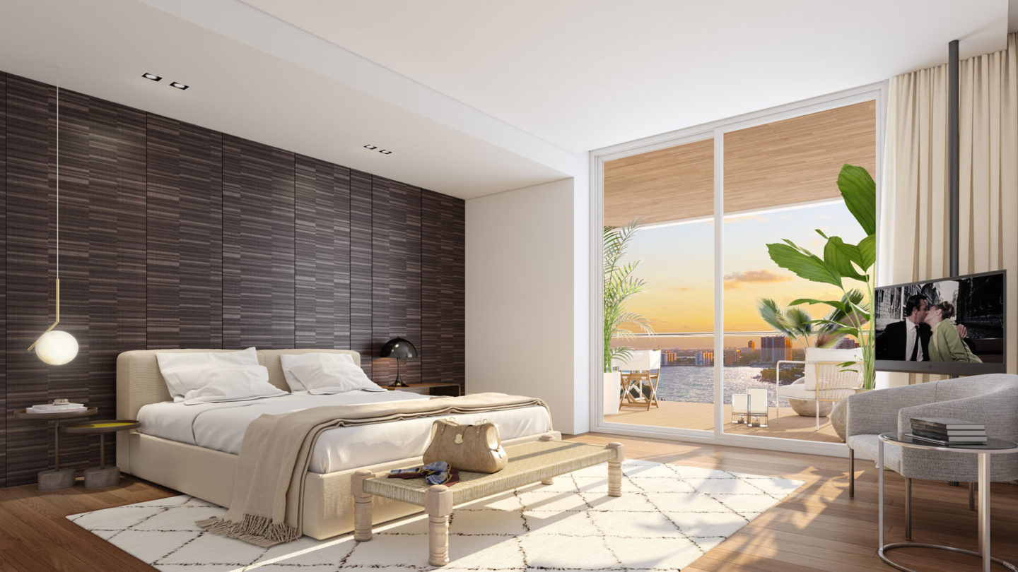 Interior view of Monaco Yacht Club residence bedroom with window view of the ocean. Has wood floors and bed in the center.