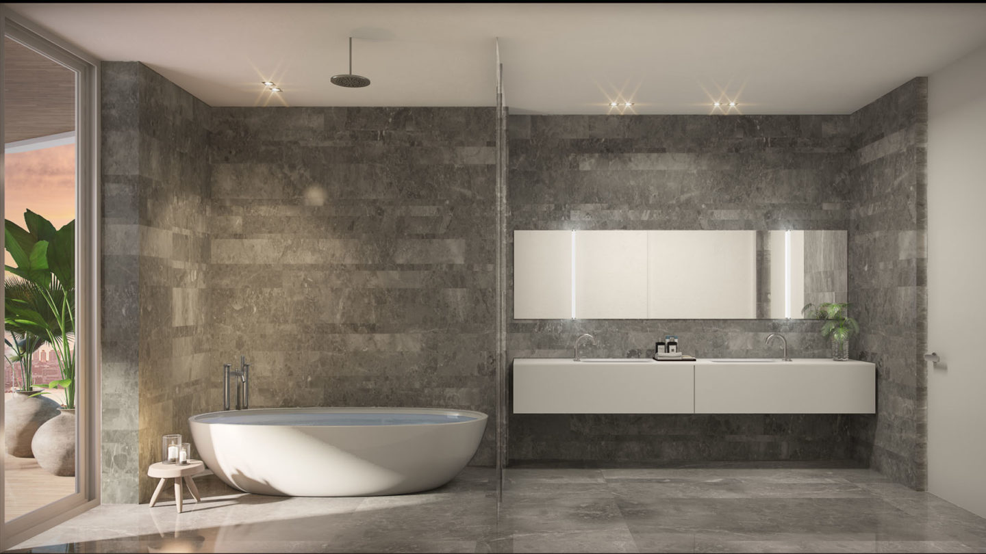 Interior view of Monaco Yacht Club residence bathroom with stoned walls and classy white tub. Open window view of the ocean.