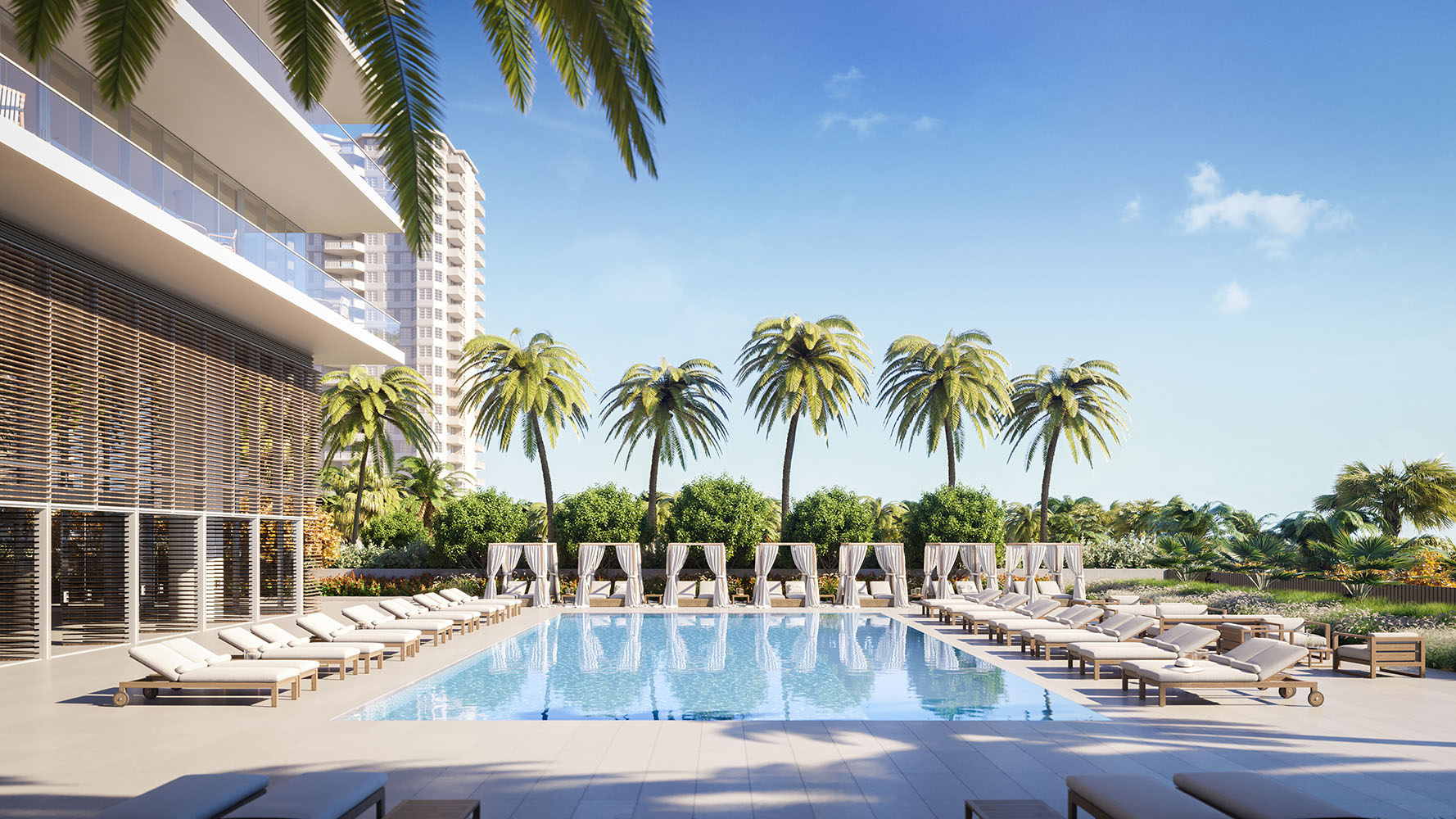 Exterior view of 2000 Ocean condominium with an ocean front pool with palm trees located in Hallandale Beach, Florida.