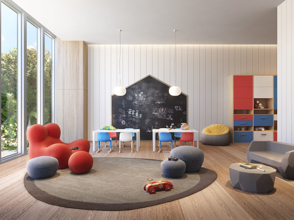 Interior view of 57 Ocean residence kids room in Miami. Has wood floors, play tables and a black board.