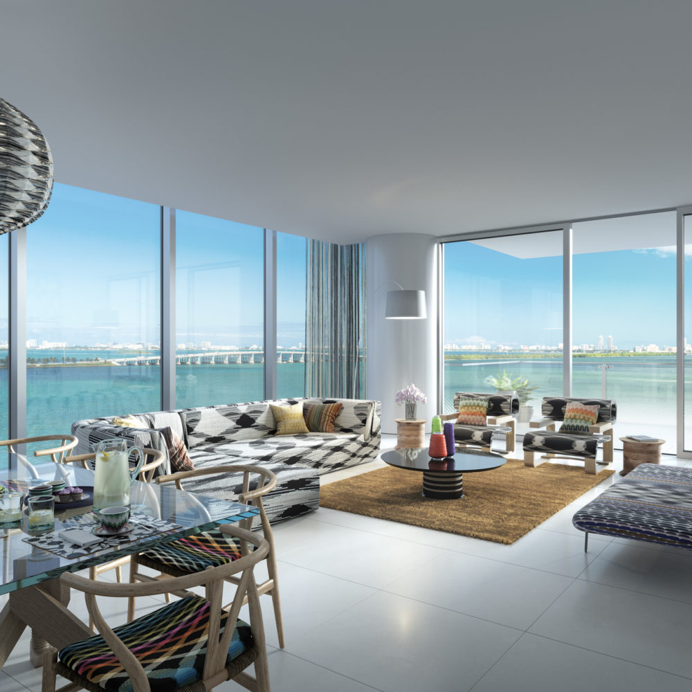 Interior view of Missoni Baia residence living room with oceanfront window view. Has glossy white floors and balcony.