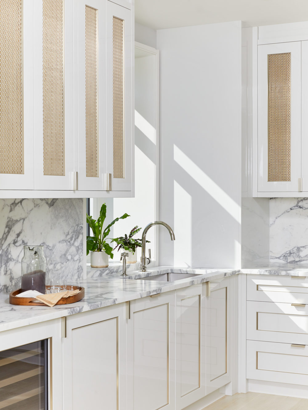 Interior view of 40 East End Ave residence kitchen in NYC. Zoomed in view of marble counters, white walls, and a sink.