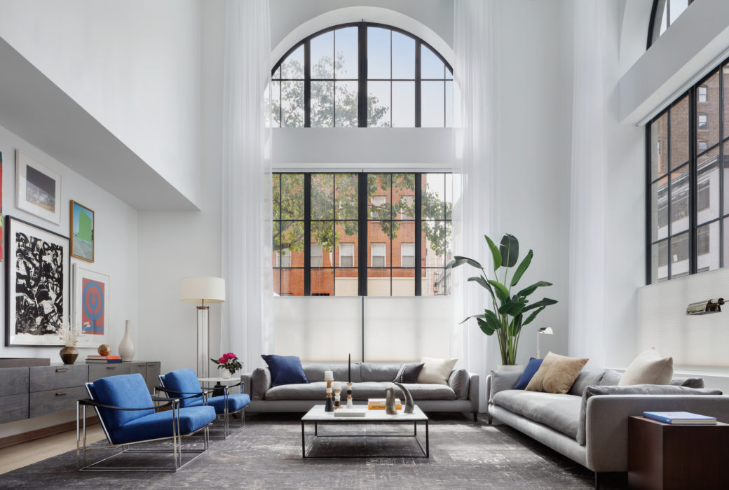 Interior view of 88 & 90 Lexington residence lobby in New York City. Has blue chairs and brown couches.