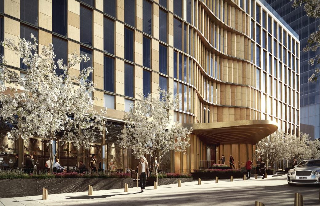 Exterior view of entrance to 35 Hudson Yards located in NYC. Includes day view with white trees and an illuminating side.