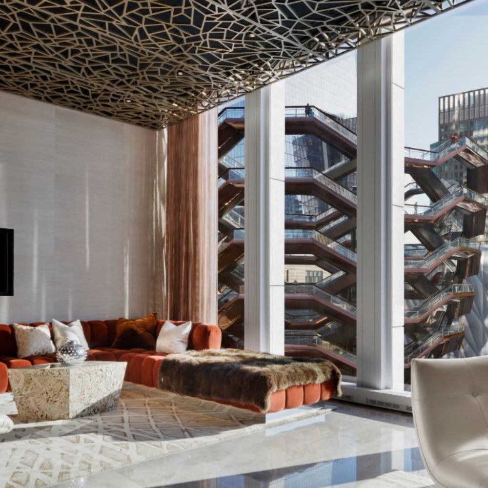 Interior view of conference room at 35 Hudson Yards condominiums with window view of New York City and glass structure.