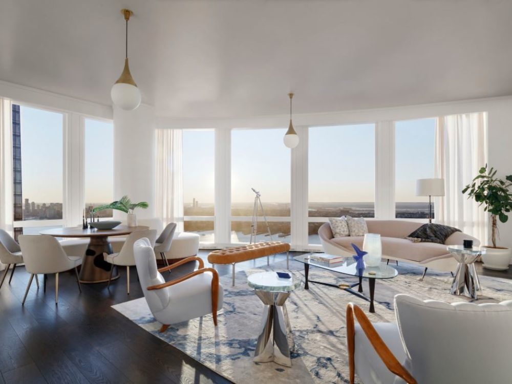 Interior view of 35 Hudson Yards residence living room with window view of NYC. Has white walls and chairs and wood floor.
