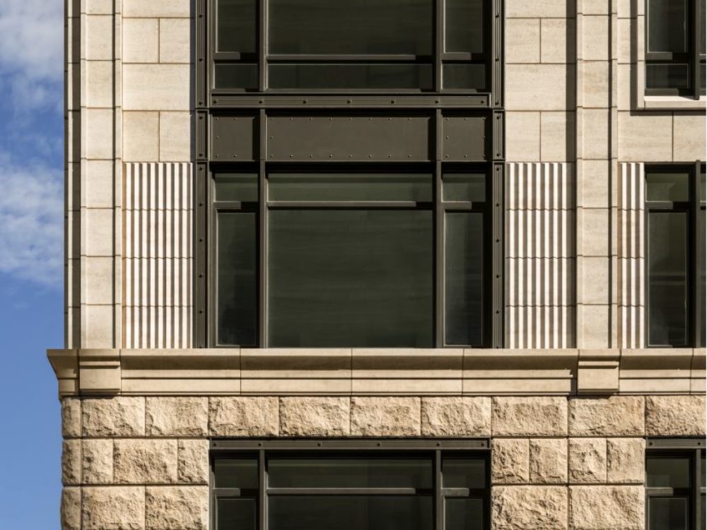 Exterior close up of 70 Vestry condominiums windows in New York City. Has brick walls and dark windows.