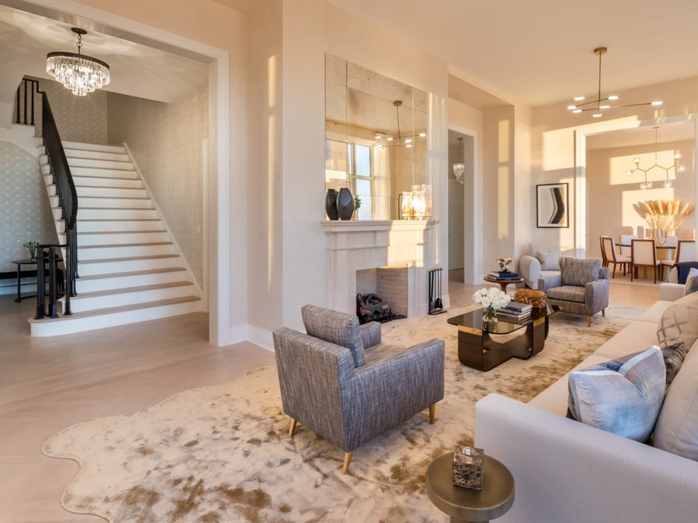Interior view of 30 Park Place residence living room. Includes full furniture and white staircase located in New York City.