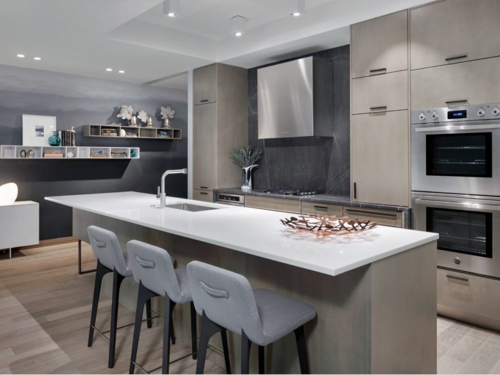Interior view of 88 & 90 Lexington residence kitchen in New York City. Has white table top, white chairs and full amenities.
