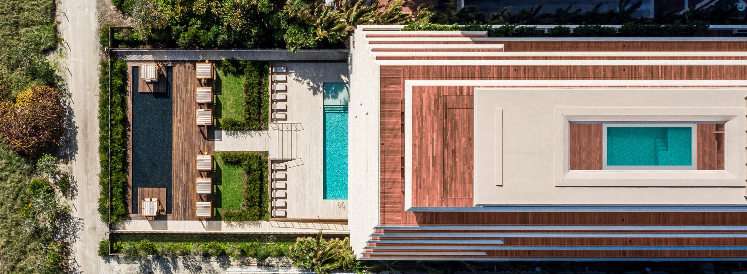 Exterior aerial view of Arte Surfside condominiums with oceanfront view. Has rooftop and front entrance pool.