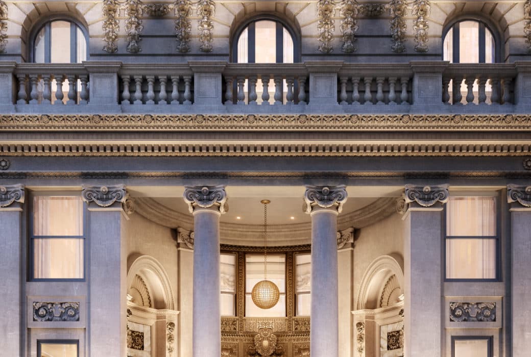 Modern renaissance grand entrance to 108 Leonard condominiums New York City at night with lights illuminating the door.