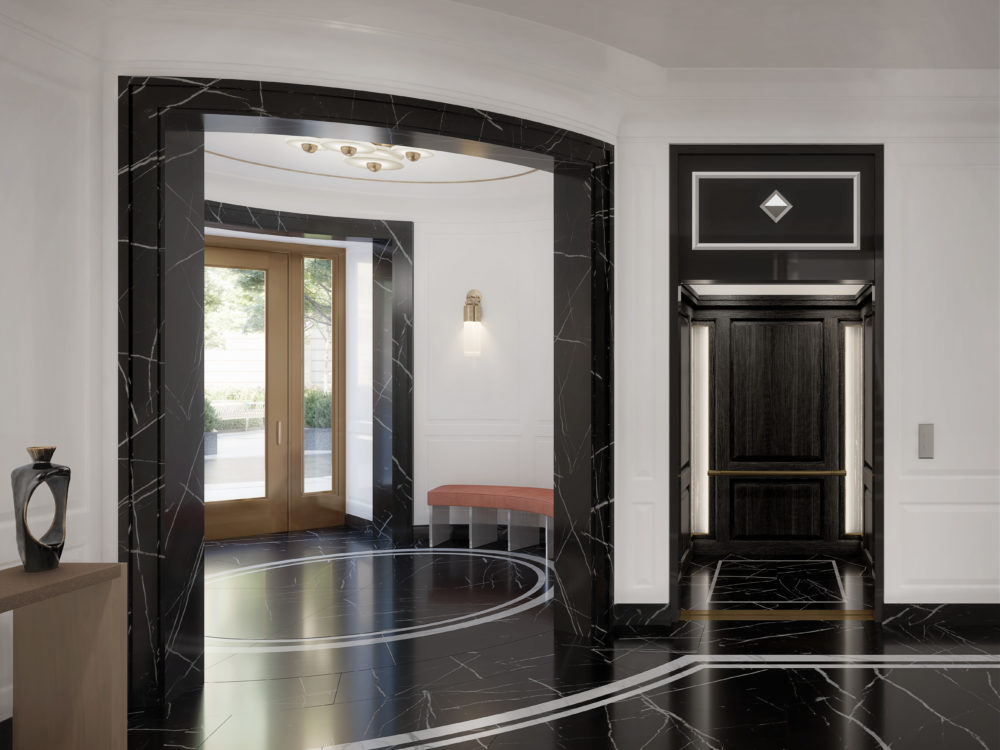 Interior lobby at The Belnord in New York. View of front doors and elevator with black marble floors and white walls.