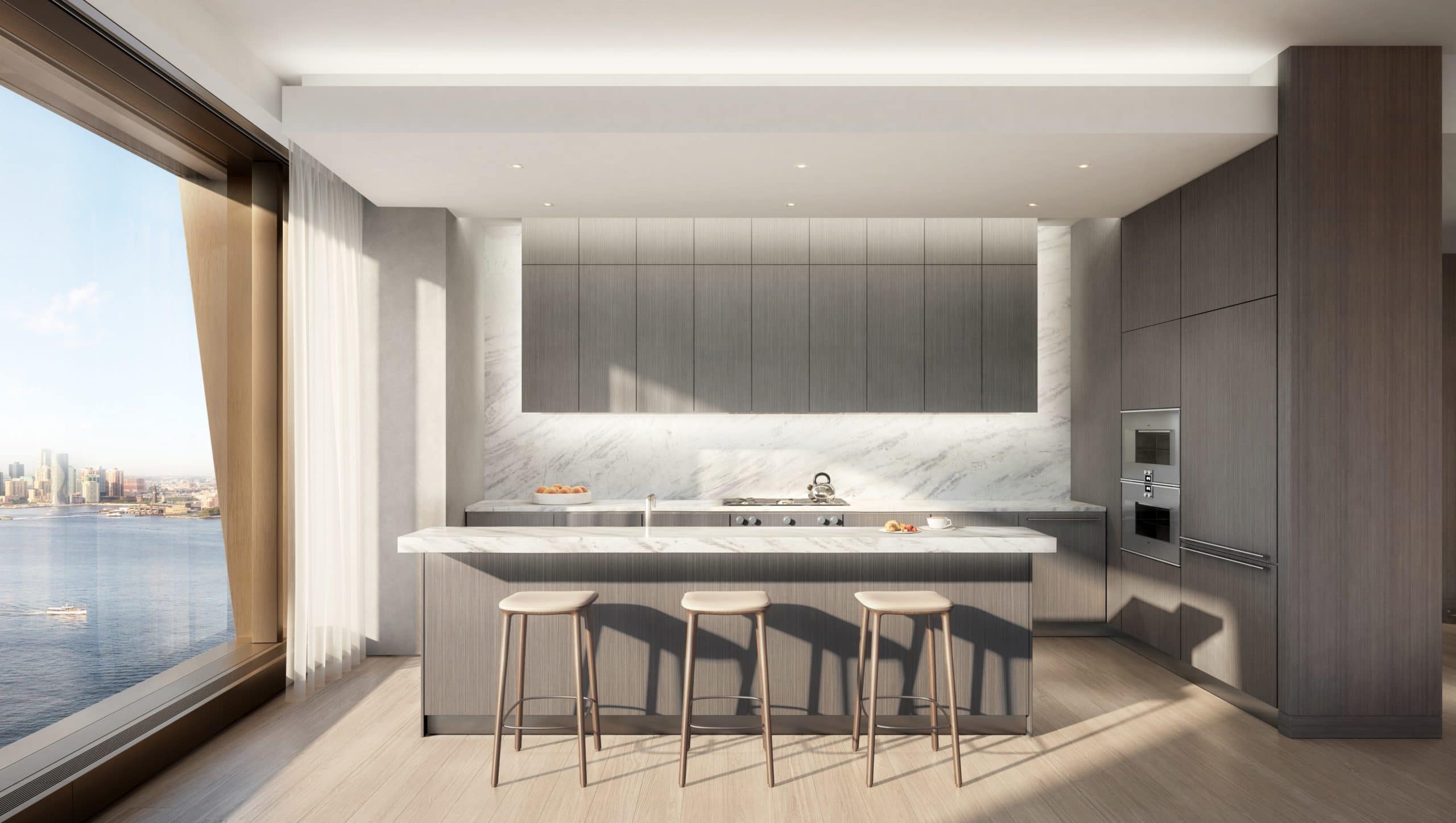 A kitchen at The Xi condos in New York. Gray walls and cabinets, a small island countertop and floor-to-ceiling windows.