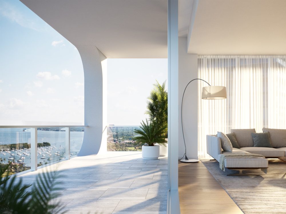 Terrace and living room at Mr. C Residences in Miami. Floor-to-ceiling windows with access to balcony from the living room.