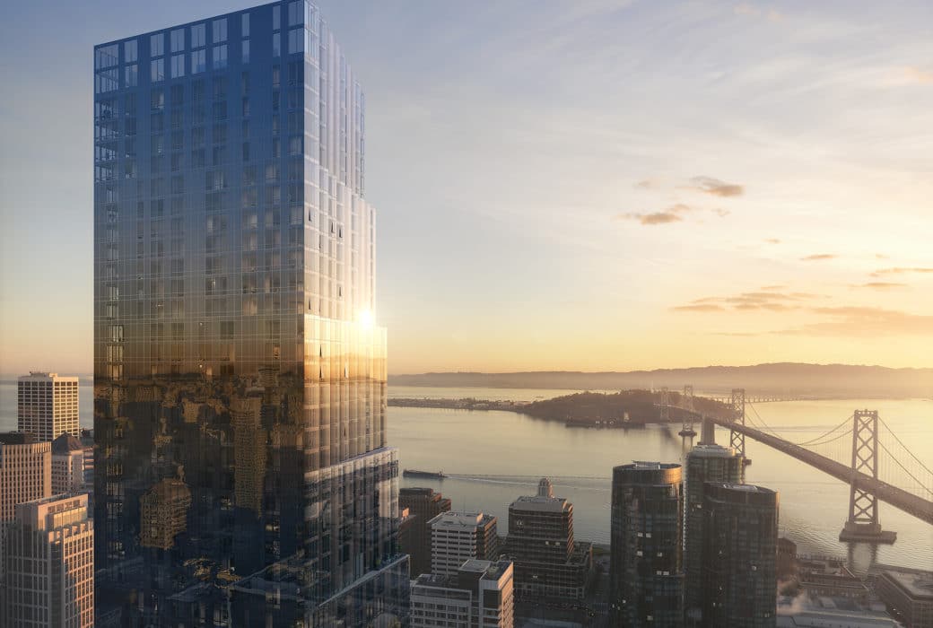 The Avery condos aerial view in San Francisco. Exterior of tower with Golden Gate Bridge and city sky line at sunrise.