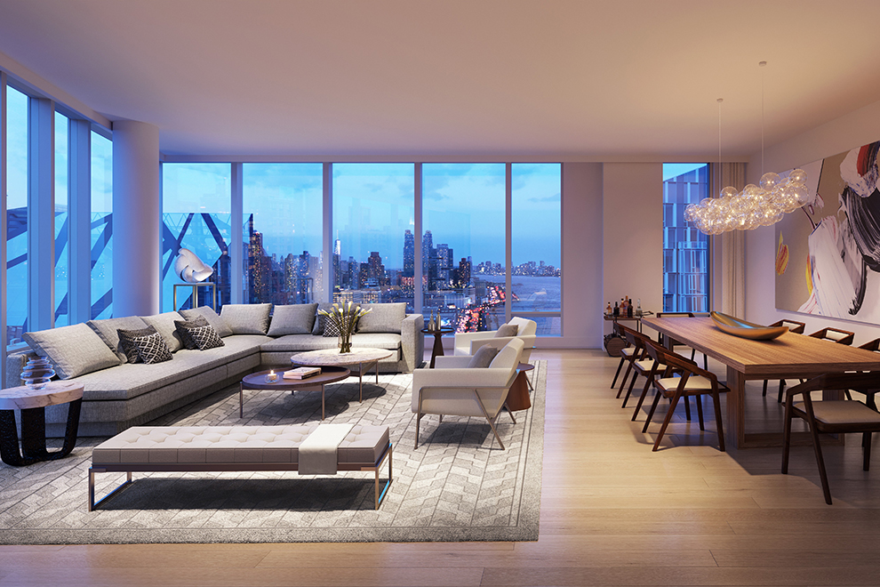 GID Development Group Open concept living room in Waterline Square condo with large windows, a long couch, and a rug over the hardwood floor.