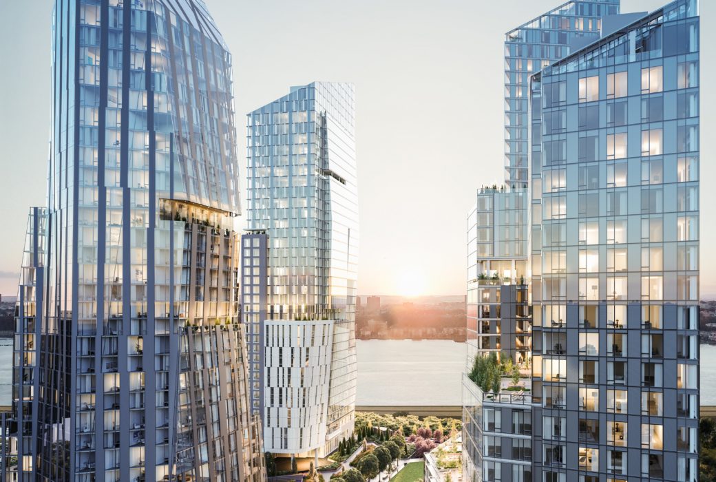 View of Waterline Square luxury residences in NYC. Three towers split by a walkway with raised planters on the Hudson River.