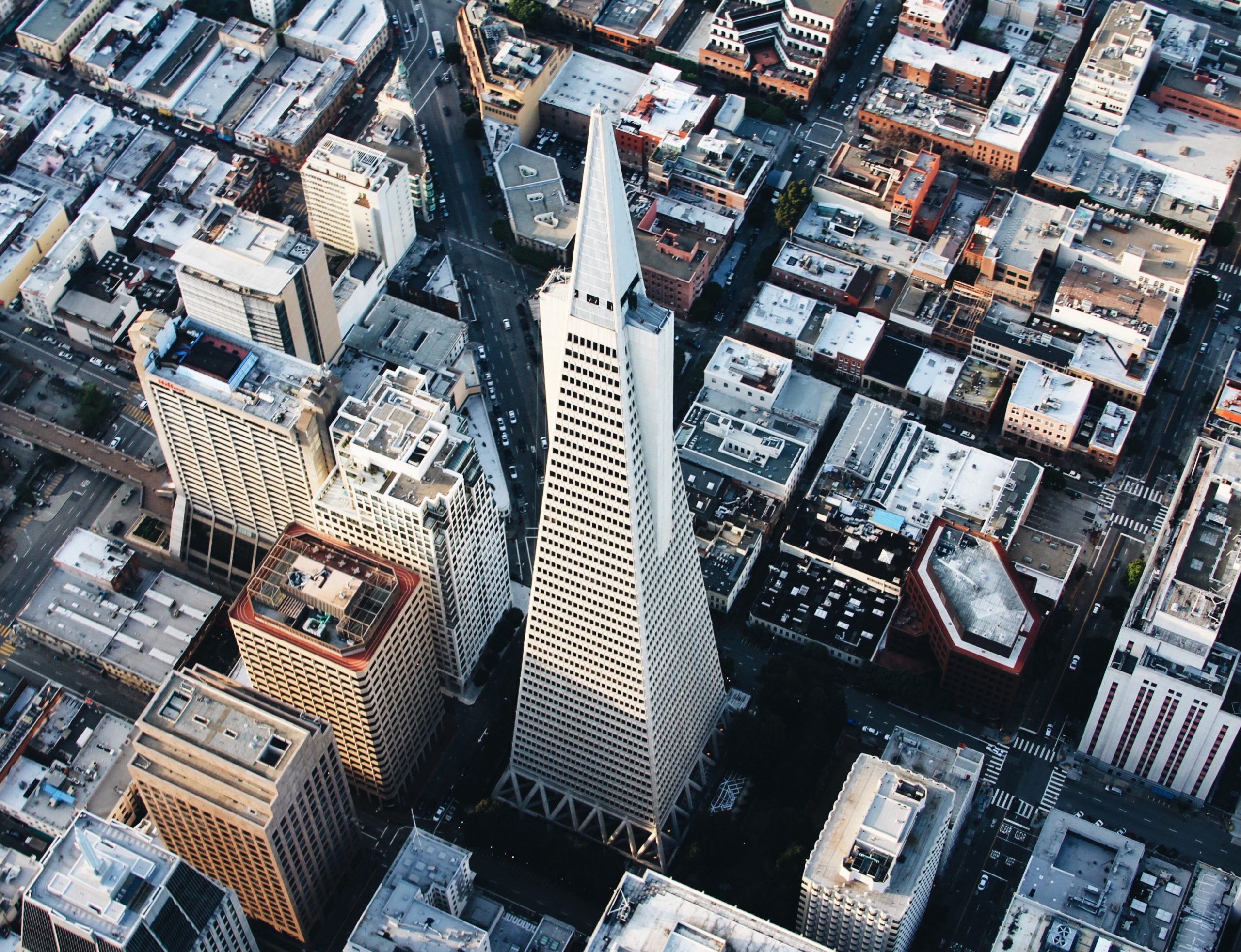 Aerial view of the Transamerica Pyramid skyscraper in San Francisco's financial district. White pointy tower in downtown.