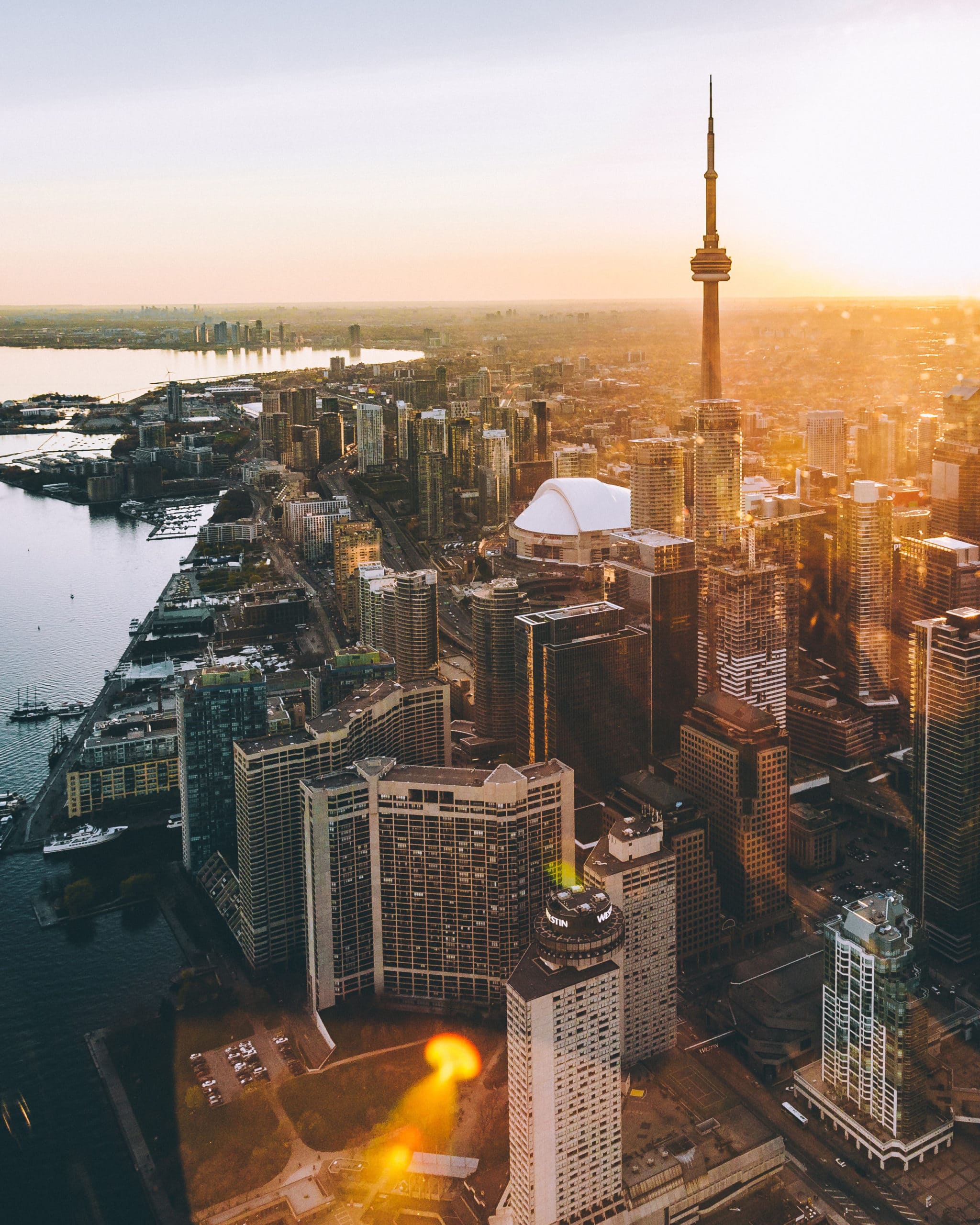 Exterior aerial view of Toronto harbor. Includes view of needlepoint and surrounding skyline buildings.