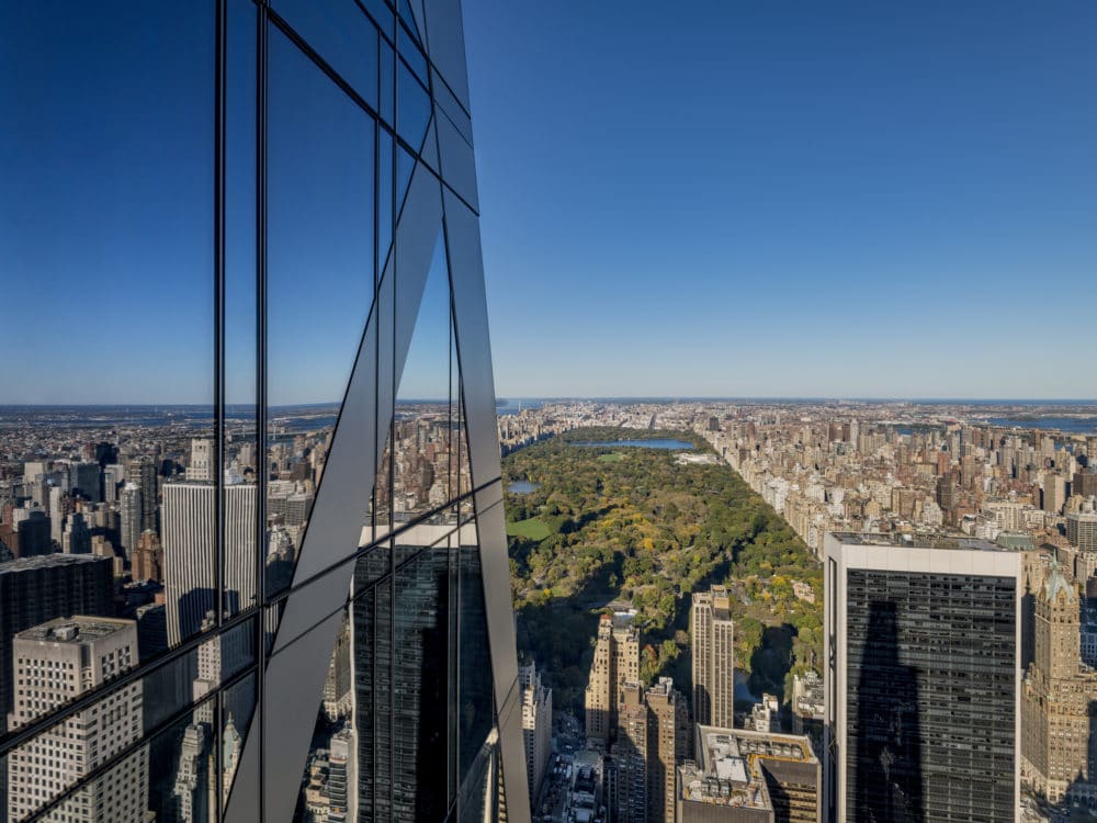 Exterior aerial view of 53 West 53 condominiums with view of New York City and central park.