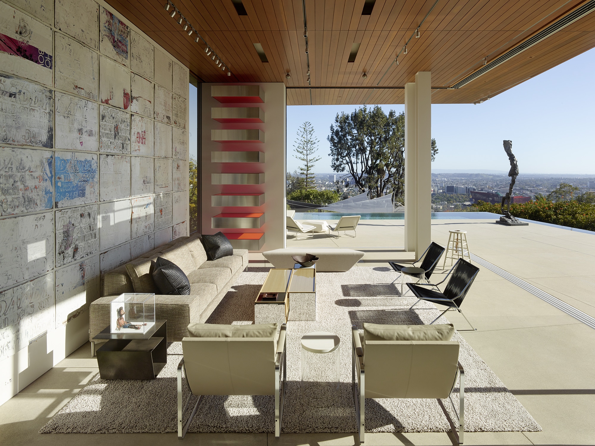 Outdoor entertaining space designed by Gary Hutton. Large seating area with wood ceiling and views of the city.