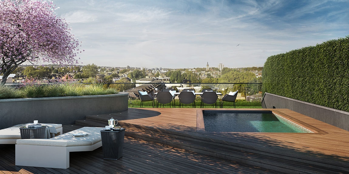 Rooftop penthouse pool at Islington Square in North London. Wood deck, lounge chairs, shrubbery, and pool with city views
