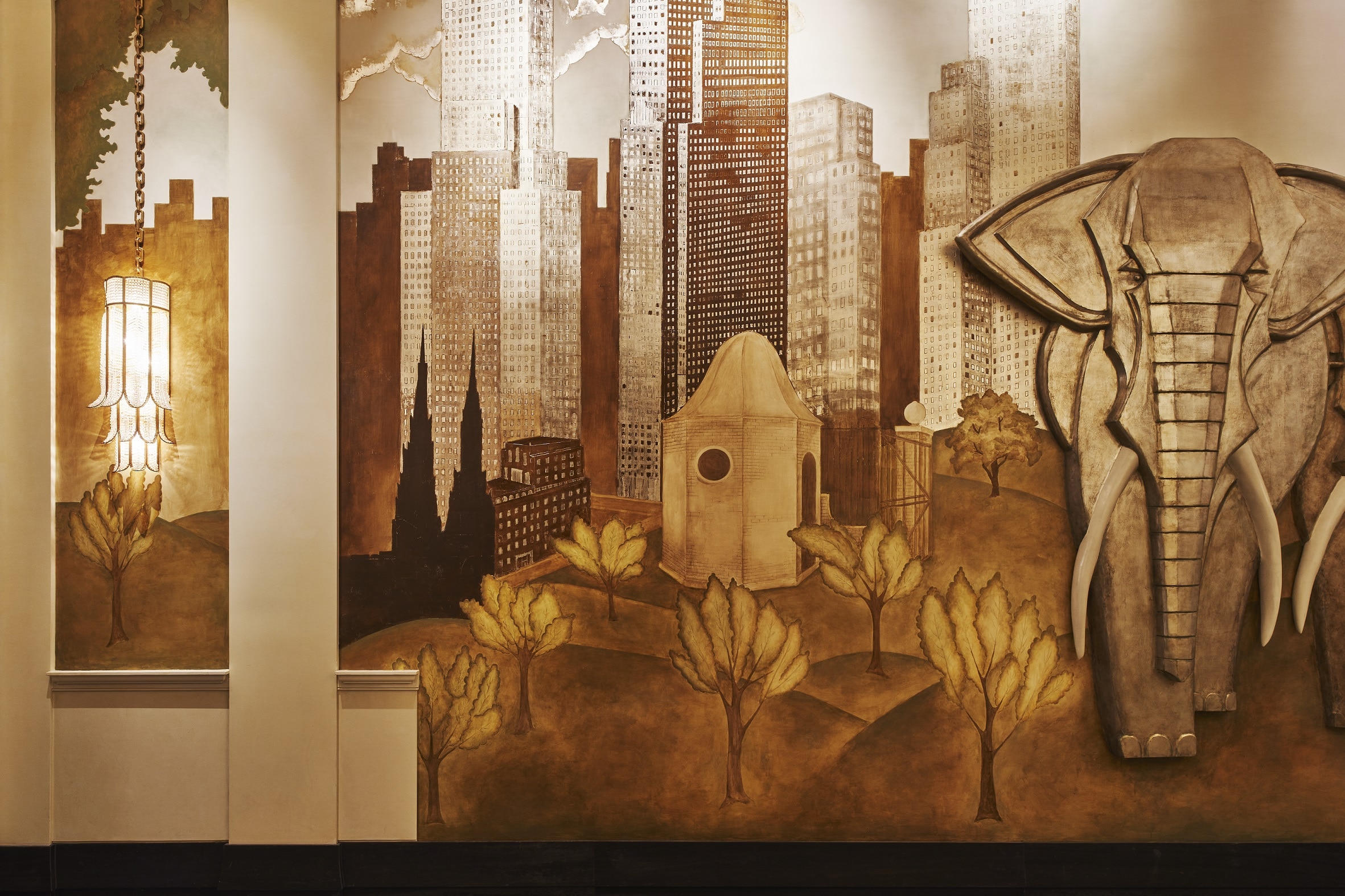 View of detailed mural with gold trim and an elephant inside the lobby of 111 West 57th street condominiums in New York City.