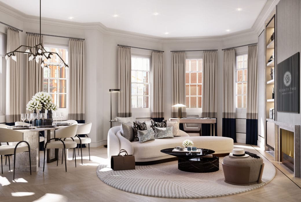 Living room at 82 Mount Street apartments in London. Open room with high ceilings, furniture, fireplace, and dining table.